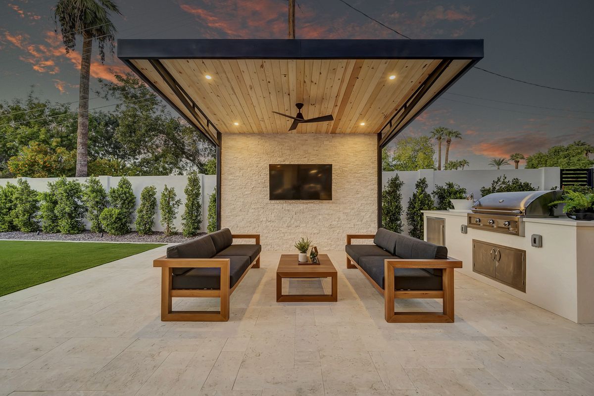 Covered outdoor kitchen and seating area at twilight, North Central Phoenix