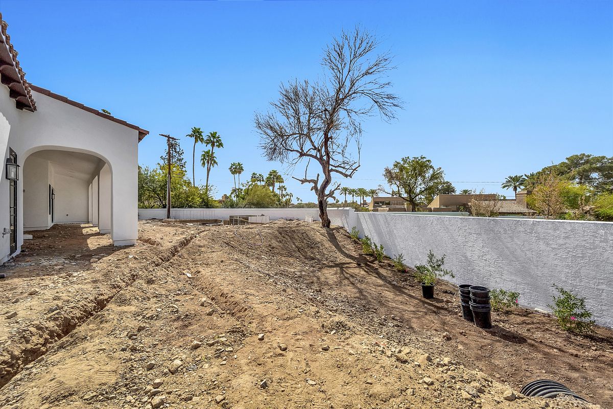 Dirt courtyard beside a Spanish style home before pavers, Arcadia, Phoenix