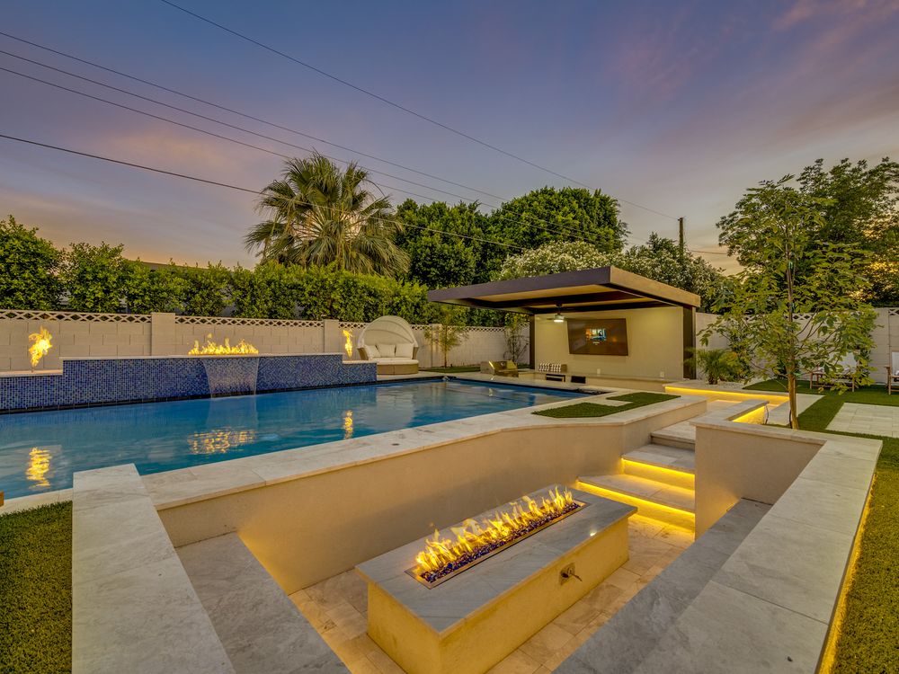 Pool at twilight with fire feature and lit steps, Scottsdale