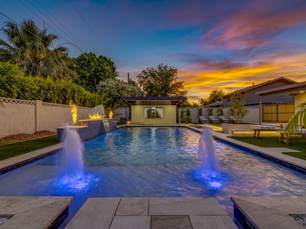 Pool with lit deck jets at twilight, Scottsdale